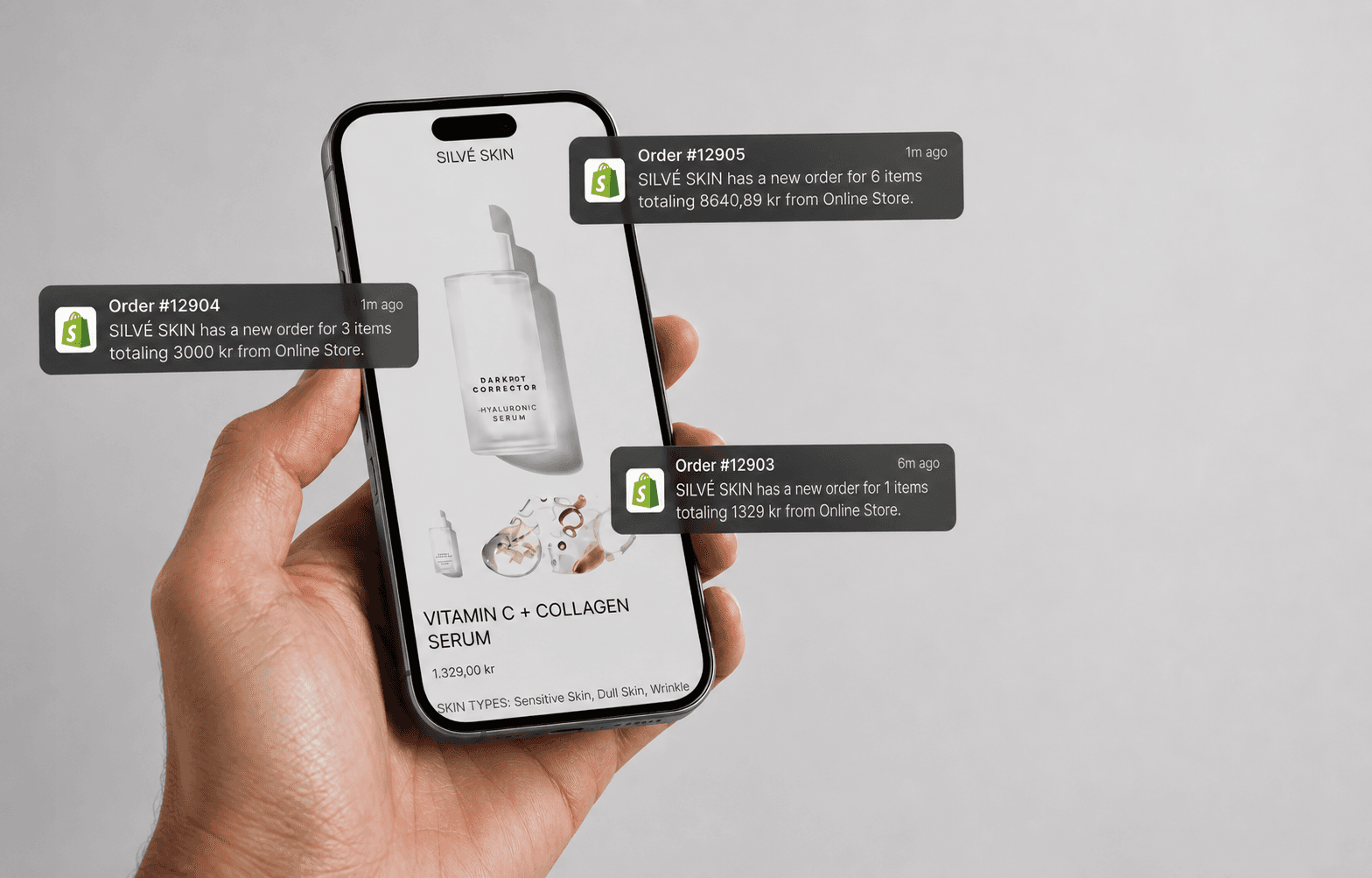 Shopify order notifications over a mobile ecommerce storefront held in hand